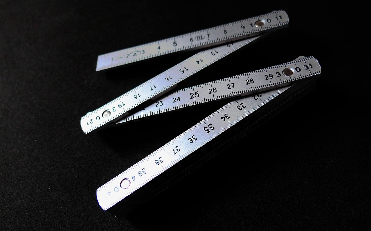 Four playing cards showing twos in various suits on a dark background.